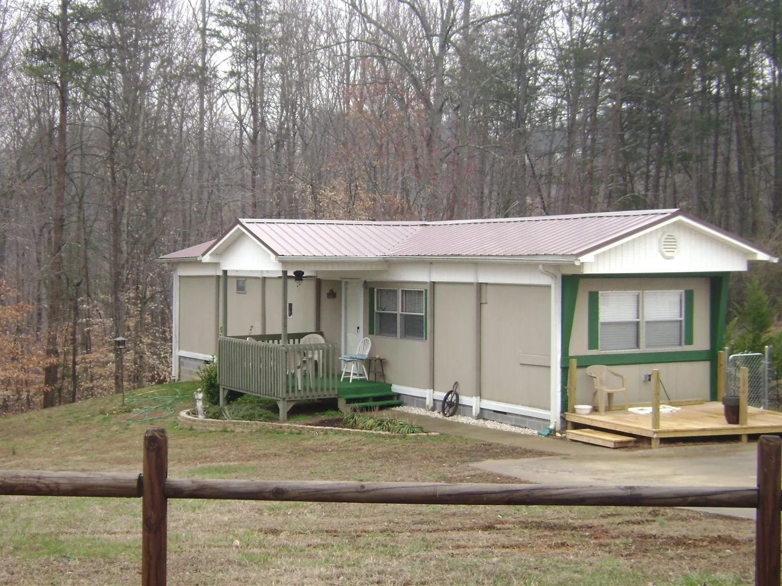 Mauve metal roof on a manufactured home with a new front deck in Nichols